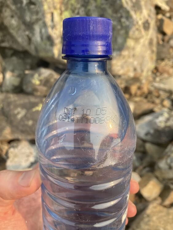 "Found an unopened water bottle while hiking hidden under rocks."