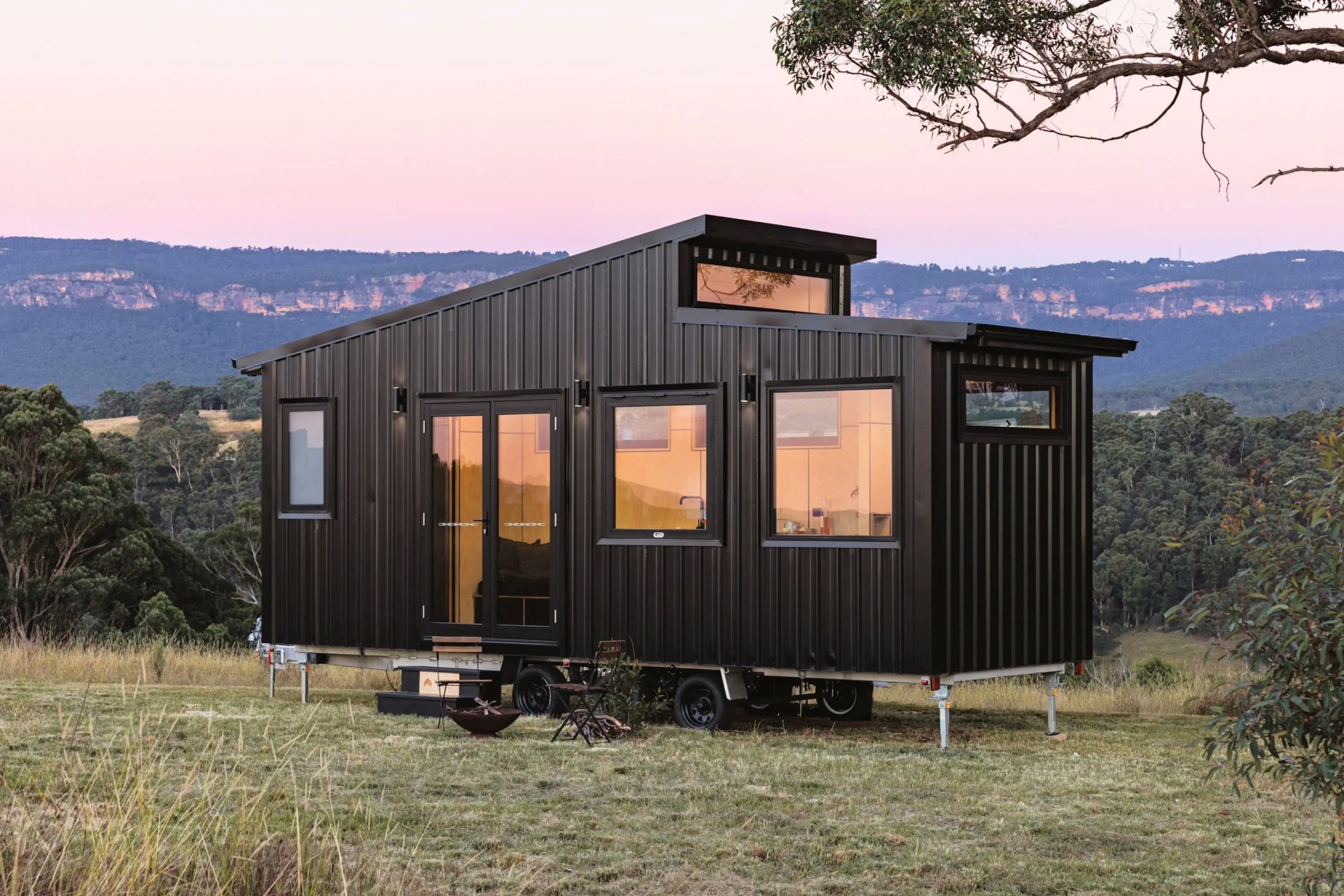 The model's open, one-floor layout maximizes natural light via ample windows, a glass double-door entrance, and a glazed metal finish that attracts sunlight.