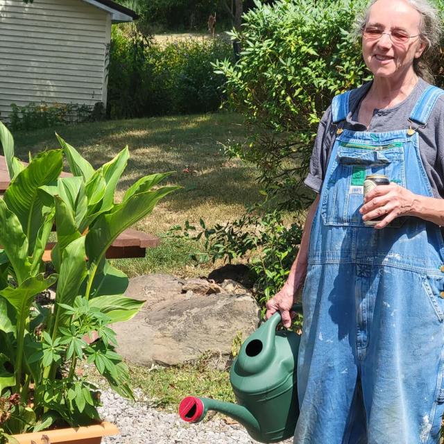 "Beer can in one hand, watering can in the other. My kind of lady."