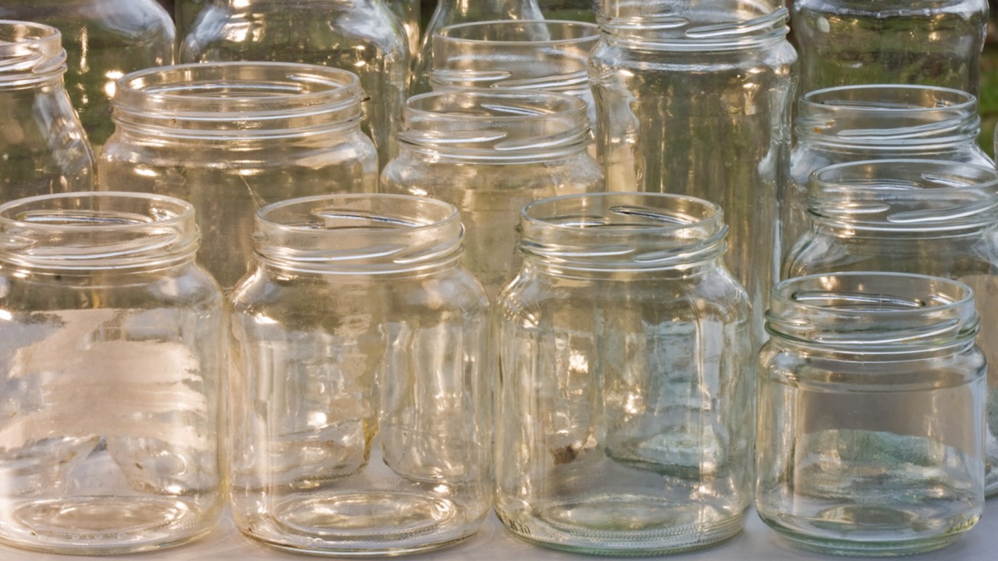 Sauce jars are sturdy and versatile, making them a great vase alternative.