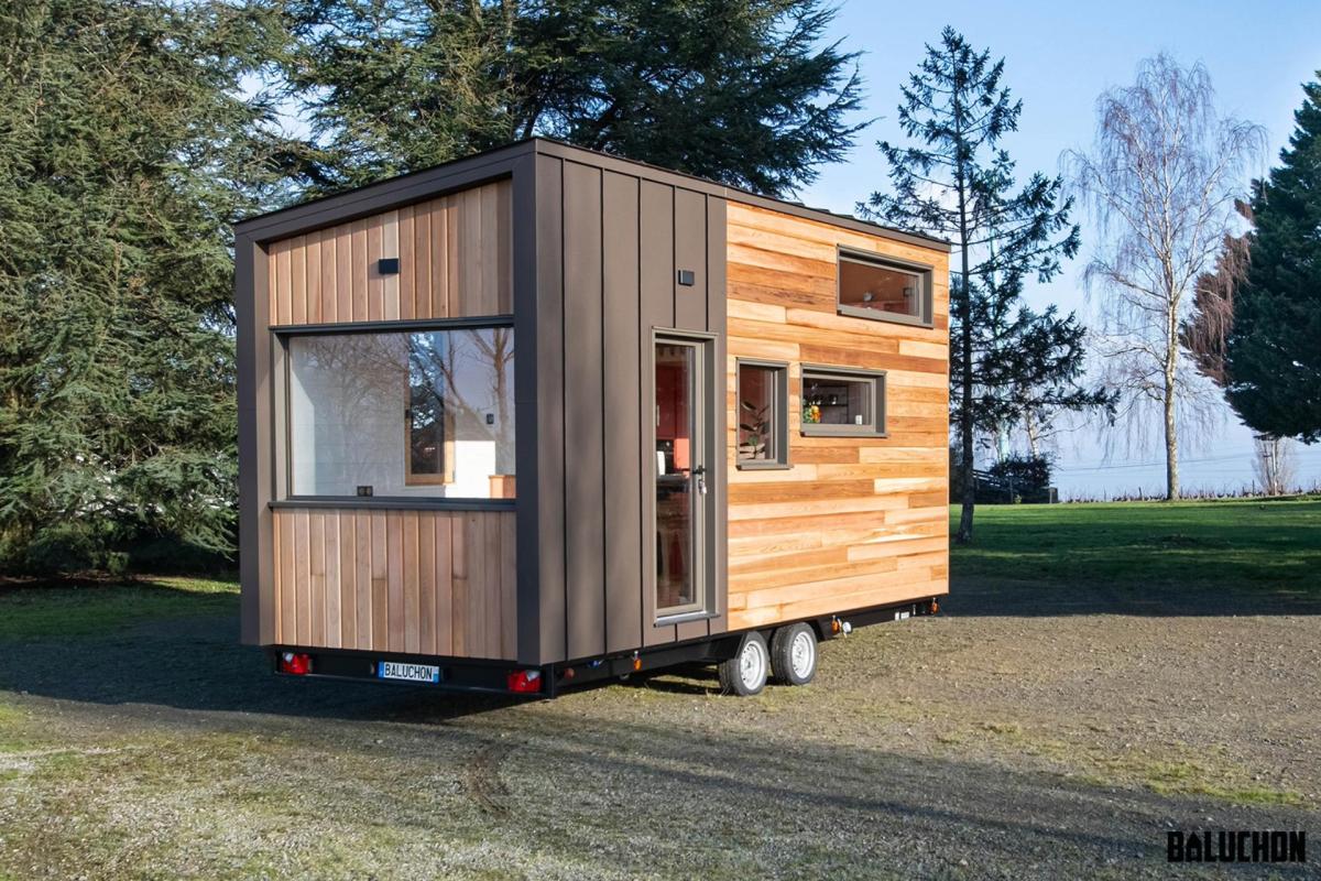 Despite the limited floorplan, the house features a full kitchen with an oven, two-burner propane stove, fridge, and sink.